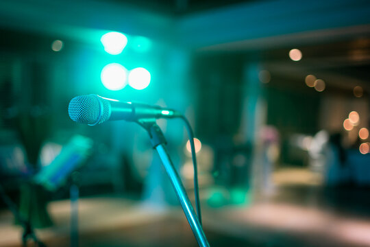 Microphone on abstract blurred of speech in seminar room or speaking conference hall light, Event Background