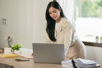 Asian woman working with customers in office