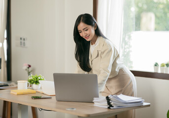 Asian woman working with customers in office
