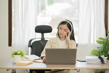 Asian woman working with customers in office