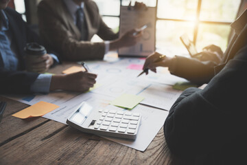 Businessman boss of the team point to graph and chart