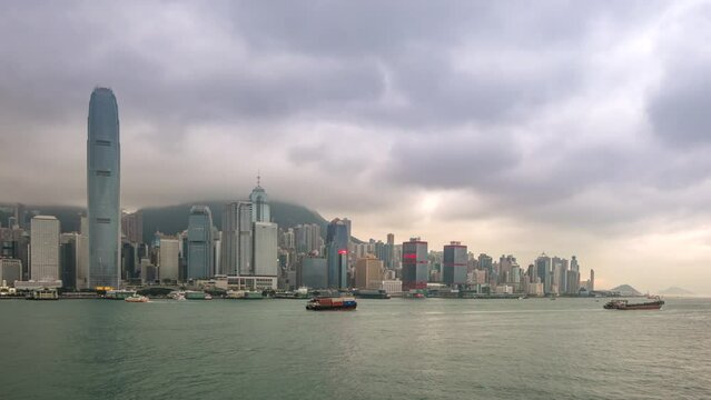 Hong Kong time lapse 4K, city skyline day to night timelapse at Victoria Bay Hongkong