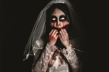 Halloween festival concept,Asian woman makeup ghost face,Bride zombie charactor,Horror movie...