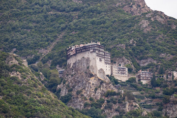 Scenic view from boat on Simonopetra Monastery (Simonos Petra) at Mount Athos, Chalkidiki, Central Macedonia, Greece, Europe. Eastern Orthodox terrain of Again Oros. Landmark build on rock formation
