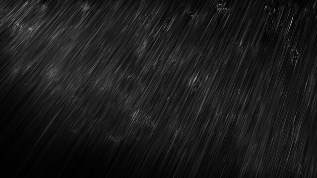 黒い背景に雨が降る画像