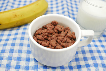 chocolate corn flakes in a bowl on table