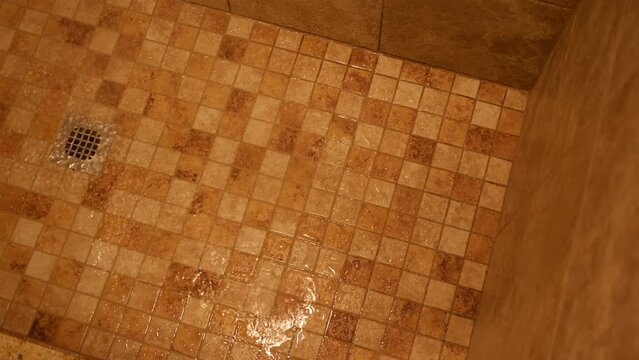 Shower water landing on tile floor of modern luxury shower