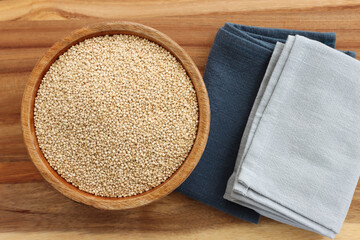 Top view image of quinoa in wooden plate on table