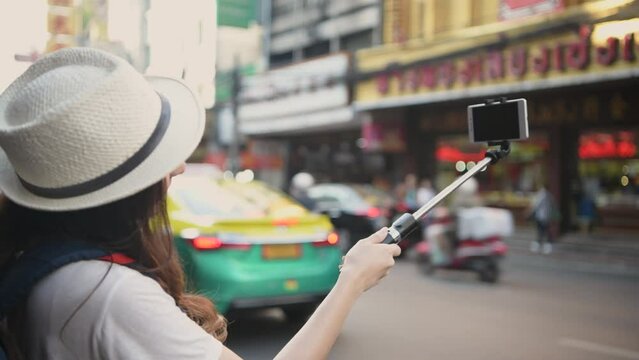 Travel concept of 4k Resolution. Asian woman taking pictures on the street while traveling.