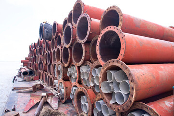 Rusted iron steel metal pipes stack an industrial field