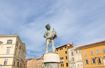 Rovinj, Istria, Croatia - September 26, 2022: Statue of "The boy with fish" on a fountain. The statue was sculpted by Marijan Kockovic and completed in 1959.