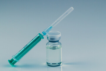 close up of glass medicine vial with syringe and needle isolated on white background. flu vaccine, doping in sport or  botox hualuronic collagen