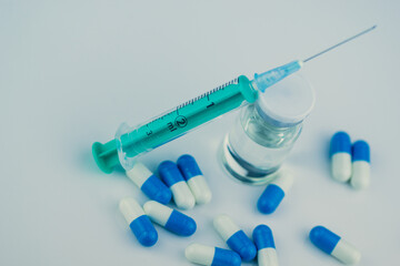 syringe with needle, vial and pills with steroids. illegal doping in sport concept