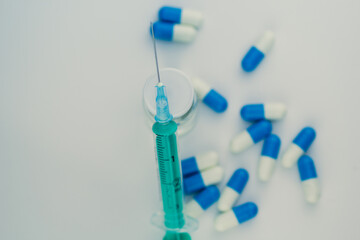 syringe with needle, vial and pills with steroids. illegal doping in sport concept