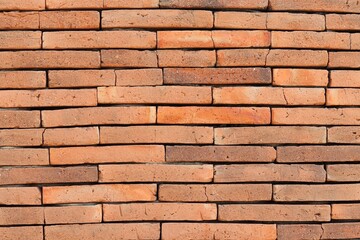 Old red brick wall background. Horizontal stacked clay bricks with natural texture, weathered surface, and rustic charm. Perfect for architectural, construction, and vintage-themed designs