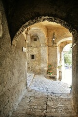 A narrow street between the old stone houses of Frosolone, a medieval village in the Molise region of Italy.