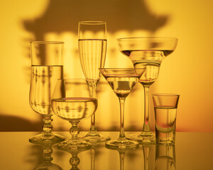 Glass goblets on a light yellow background