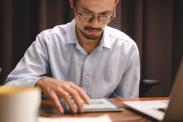 business communication technology concept, businessman person using digital pen to working on tablet computer screen device in modern office workplace, online marketing document on desk table