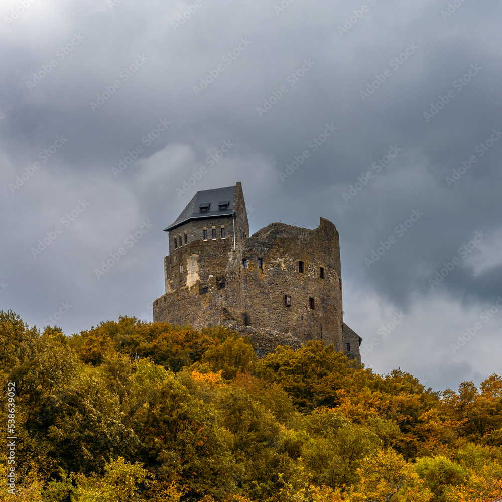 Sticker view of the 14th-century medieval castle in holloko with forest in autumn colors beneath