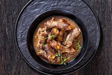 german beef rouladen in thick gravy in bowl