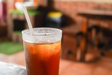 sweet cold iced tea in a transparent plastic cup