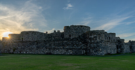 view of the historic Beaumaris Castle in Anglesey at sunset