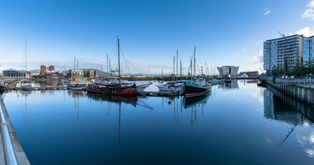 boats moored in the harbor in the Titanic Quarter of Belfast on the River Lagan with the Titanic Museum in the background