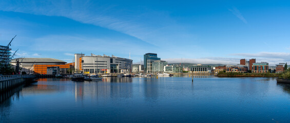 skyline of downtown Belfast with reflections in the calm River Lagan at dawn