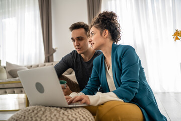 woman and man use laptop computer at home family work leisure concept