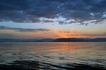 Leaving Corfu early in the morning with the sun rising from the mountains of Albania.
