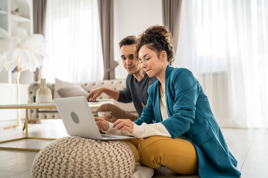 woman and man use laptop computer at home family work leisure concept