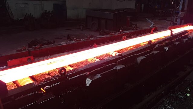 molten metal moves on rollers, production of metal products. steel foundry, metal rolling production. section rolling shop