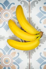 Branch of beautiful natural ripe bananas on beautiful stylish background, top view