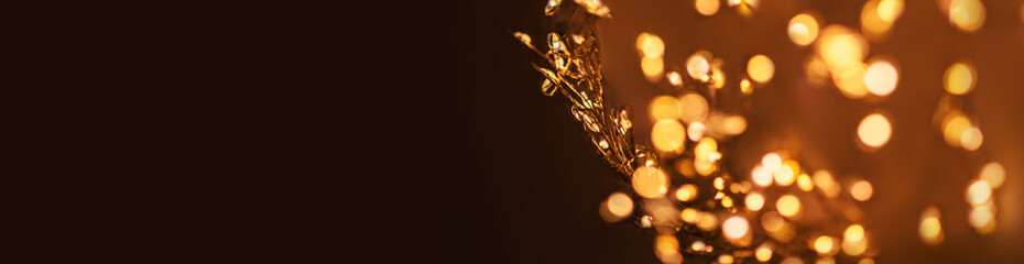 Christmas golden lights Background. Abstract twinkled bright bokeh defocused lights wallpaper. Copyspace.