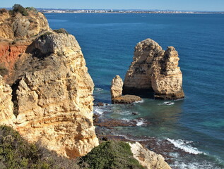 Naklejka premium Typical rocky coastline near Lagos, Algarve - Portugal