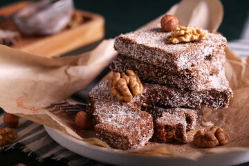 brownie cake with coconut and nuts. chocolate dessert with coconut. a piece of chocolate cake with coconut chips.