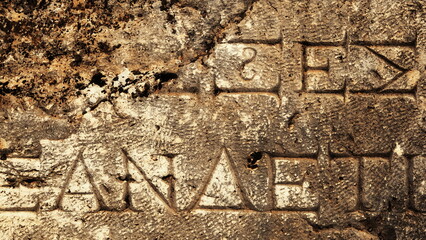 Ancient Latin Inscription on Stone near modern Pamukkale. Letters Carved in Stone. Distressed Surface Texture Background