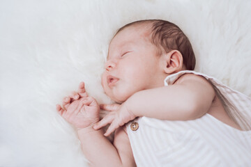 portrait of a sleeping baby lying on a fur - obrazy, fototapety, plakaty