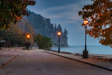 Beautiful scenery of the autumnal alley by the sea cliff in Gdynia Orlowo at dawn, Poland