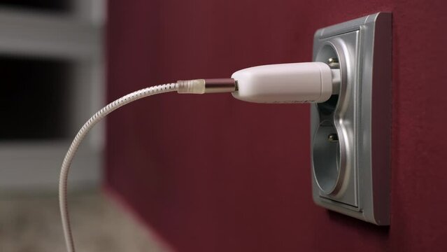 Charging gevice  ac adapter into electricity socket a power adapter cord usb device mobile phone cell charge