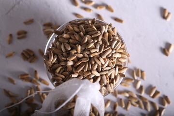 milk thistle is dry in a bag on the table. milk thistle for brewing. a healthy drink.