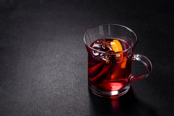 Christmas mulled red wine with spices and fruits on a concrete table