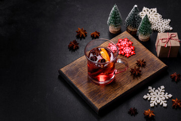 Christmas mulled red wine with spices and fruits on a concrete table