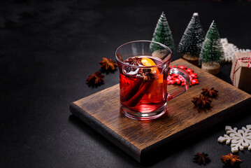 Christmas mulled red wine with spices and fruits on a concrete table
