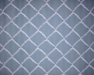 White snowflakes on a metal fence.