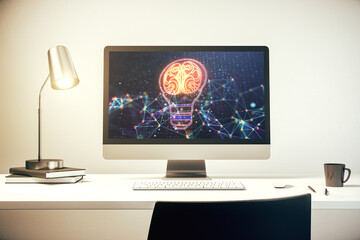 Modern computer monitor with creative light bulb hologram with human brain, idea and brainstorming concept. 3D Rendering