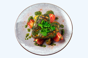 Grilled heart-shaped chicken breast with fresh tomatoes and chimichurri sauce. Bunch of fresh parsly herb. Isolated plate.