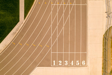 Over head view of running track at an outdoor sports stadium. Athlete POV of racing along athletic stadium and running track. Competition sports and champion hard workout. - 538658272