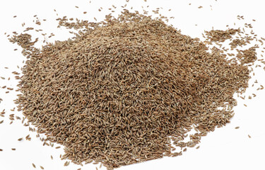Heap of cumin seeds isolated on white background