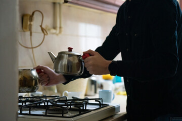 person in the kitchen makeing turkish tea